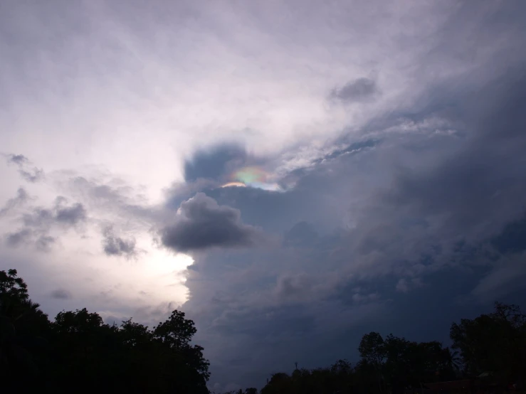 a single rainbow in the dark cloudy sky