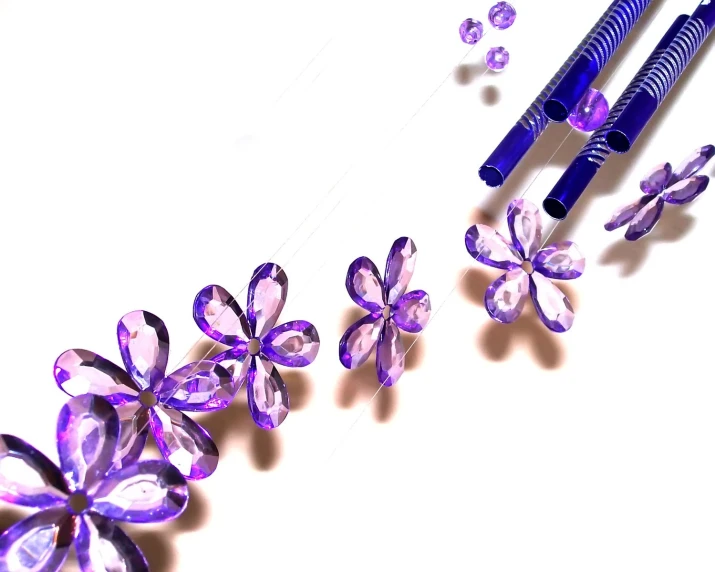 two purple flowers sit next to each other in front of a purple tooth brush