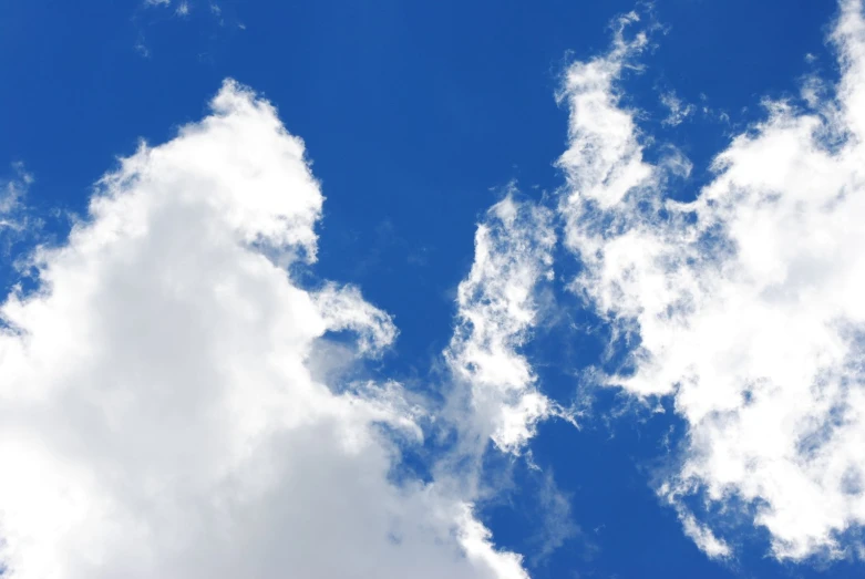 two clouds in a blue sky with white clouds