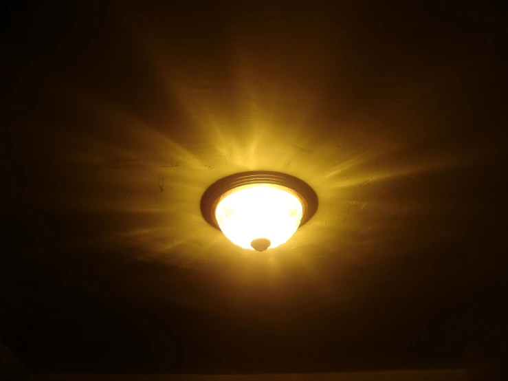 a street light with the sun coming through it