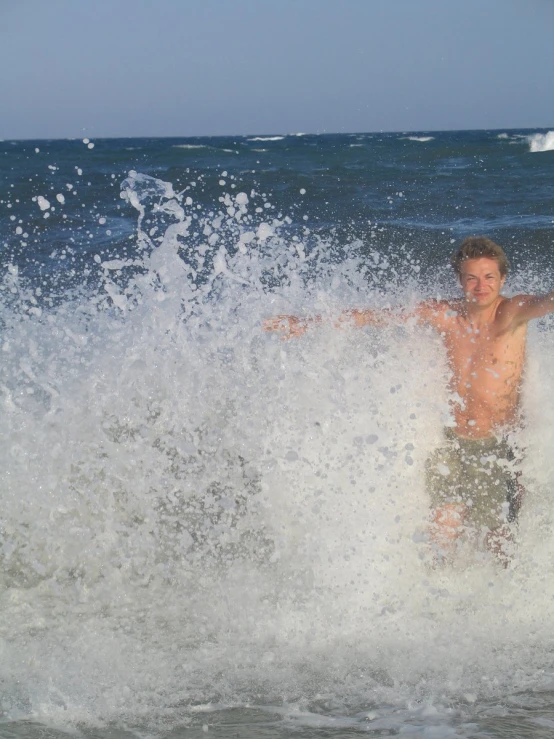 a man riding a surfboard on top of a wave