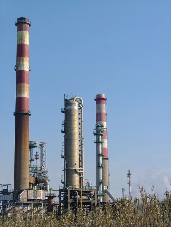 an industrial landscape including two chimneys, and some buildings