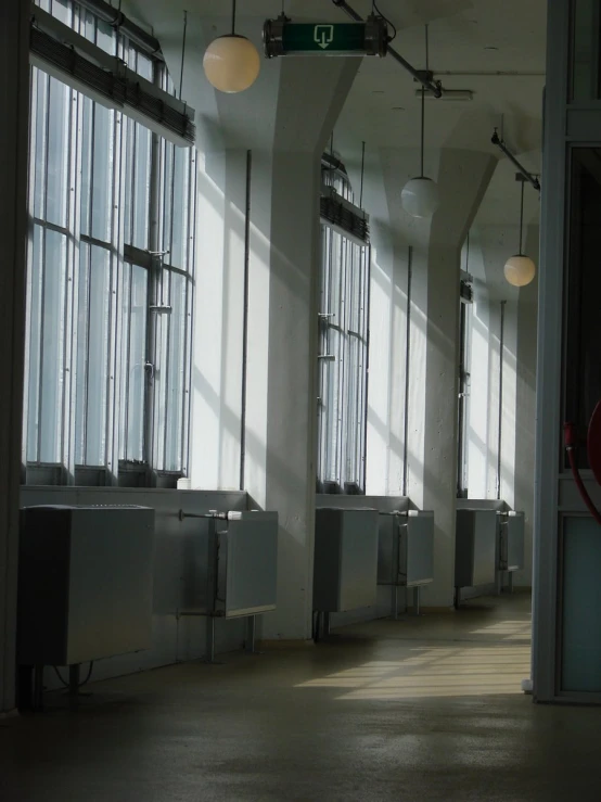 a view of a very long room with many light from the windows