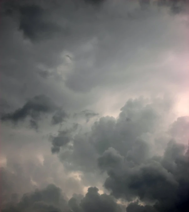 a plane flying by in a cloudy sky