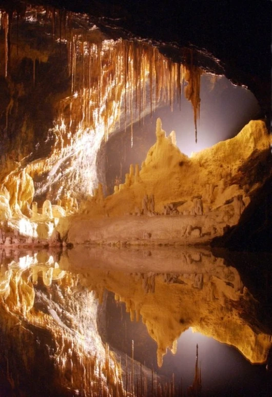 the inside of a cave with water at night