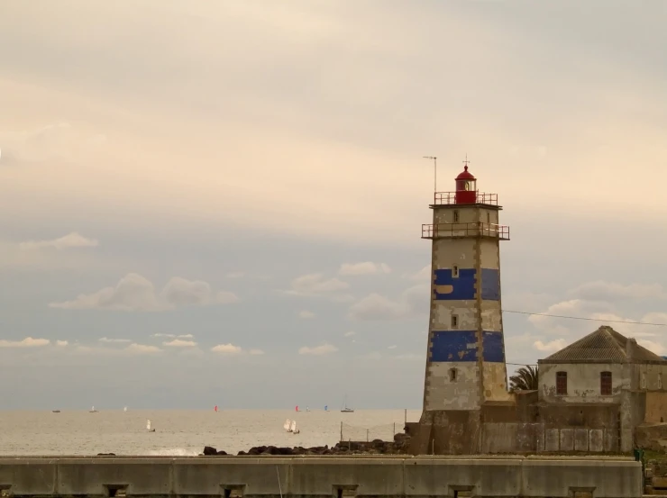 a large light house in the middle of the ocean