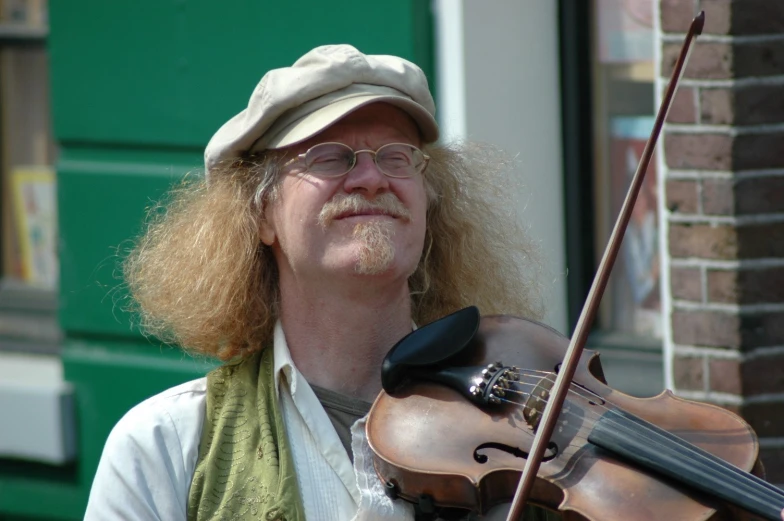 a man playing violin in a city street