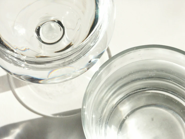 the top half of two clear water glasses