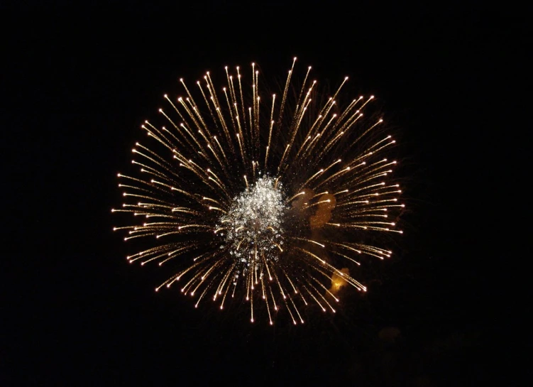 a fireworks show with bright lights in the dark sky