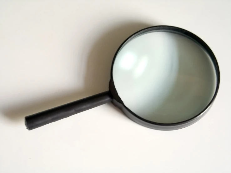 a magnifying glass sitting on top of a table