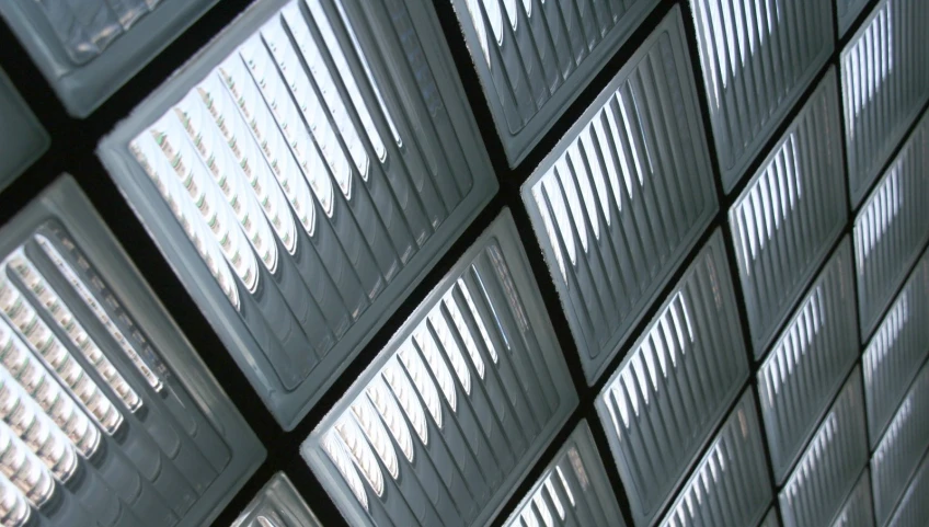 many different square glass panels against a white wall