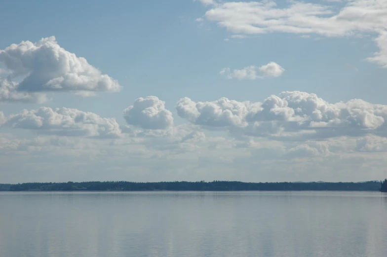 there is a large body of water with clouds above it