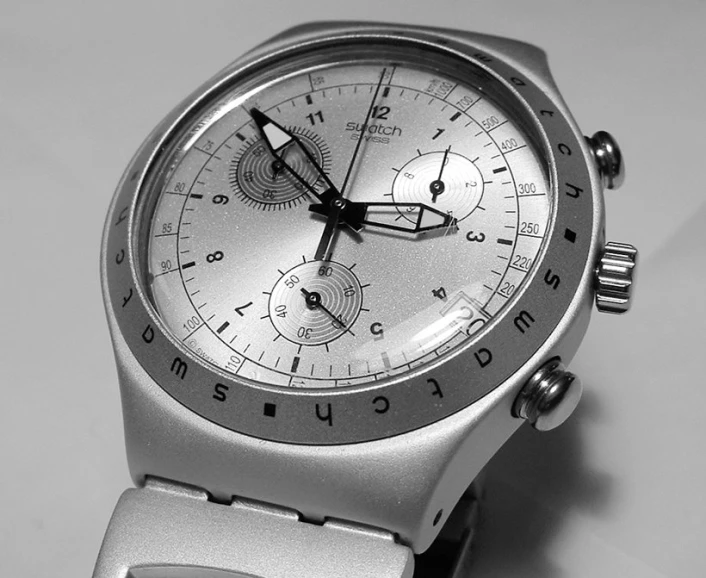 the white and gray wristwatch is on a table