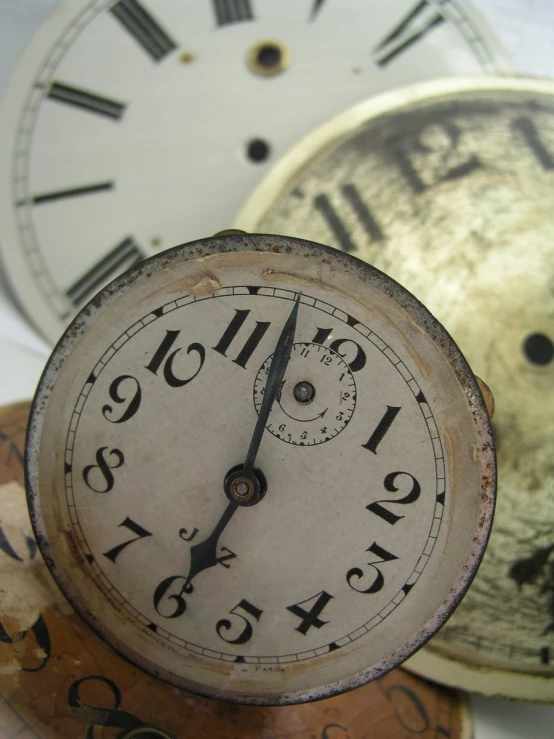 a bunch of old clocks sitting on top of each other