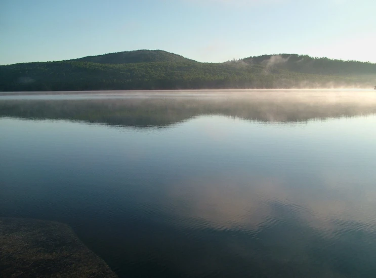 some misty water and mountains in the distance