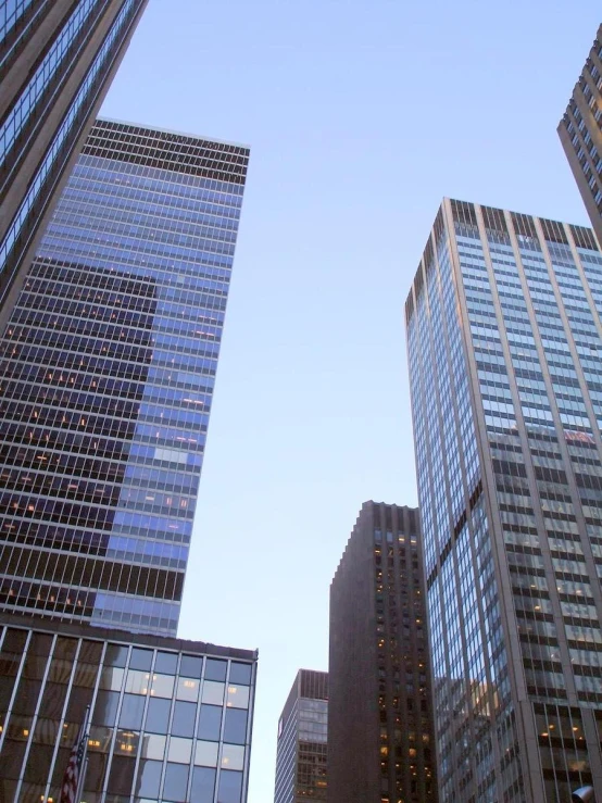 three large buildings are shown against a clear blue sky