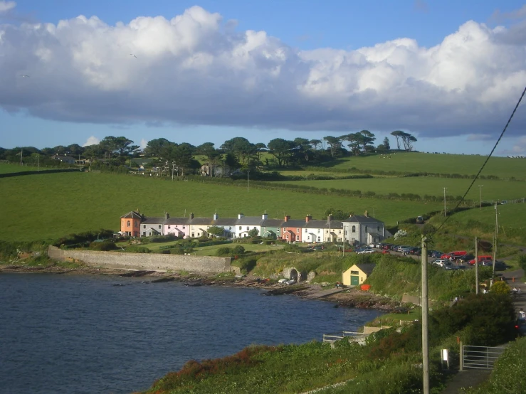 the village and lake are surrounded by lush green hills