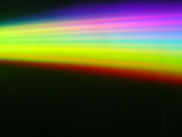 colorful, psychedelic rainbow - colored rays on black background