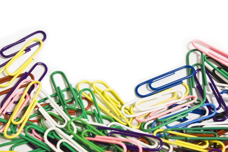 a pile of colorful paper clips on top of each other