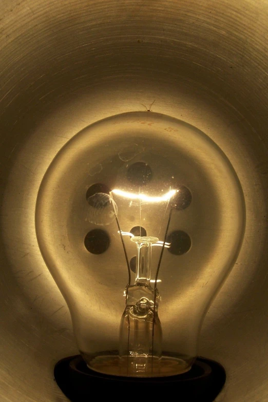 an electric light bulb turned on inside a white room