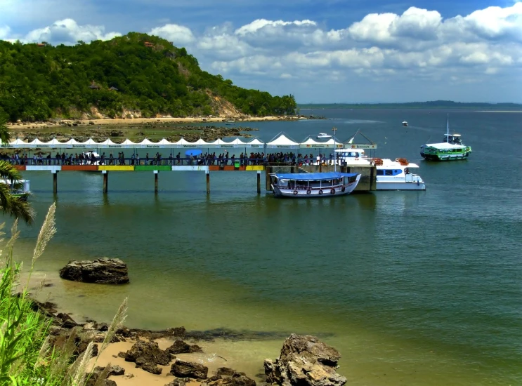 several boats in the water near a dock