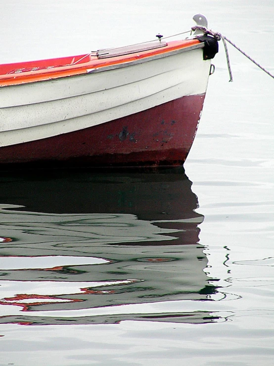 a boat with the bow tied in to it sitting in water