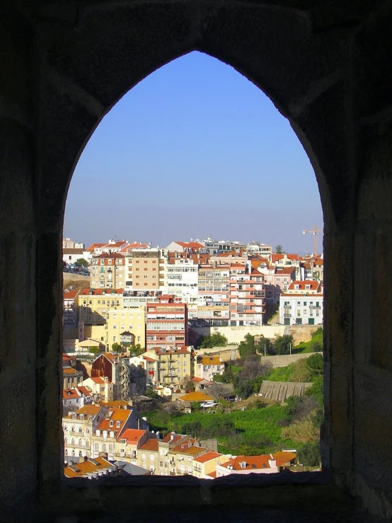 there is a city viewed from inside a medieval structure