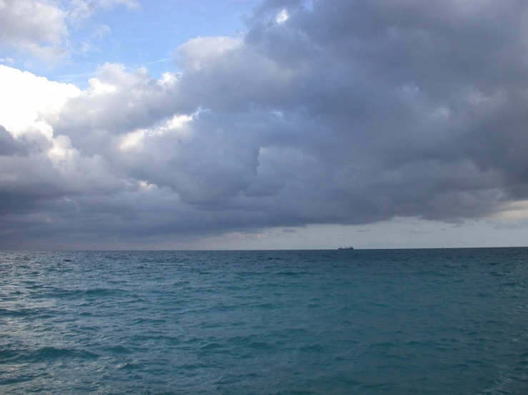 there is clouds in the sky over the ocean