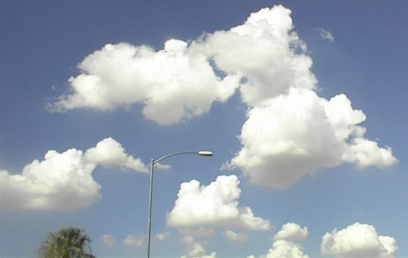 there is clouds in the sky and a street light