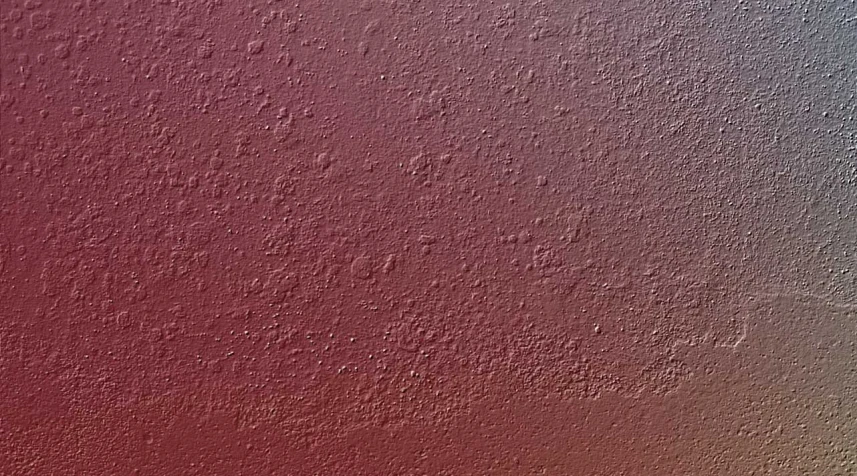 the texture of a red wall painted in grey and pink