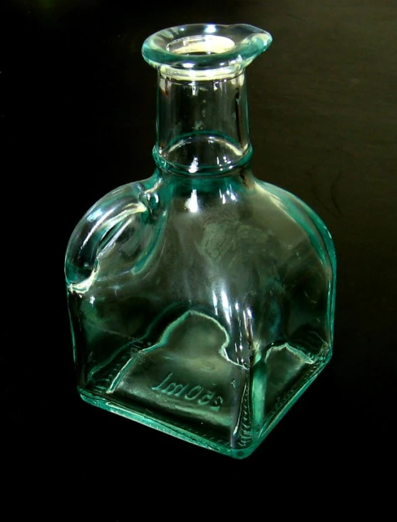 a clear glass flask with a lid in the shape of an elephant