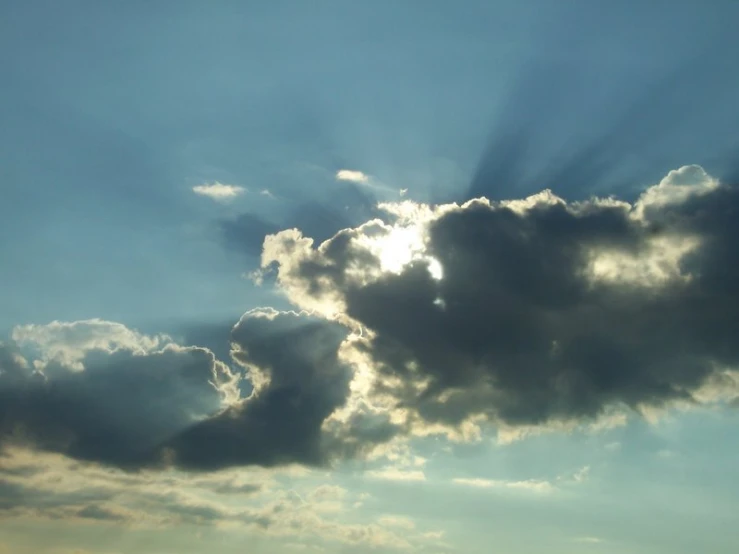 bright light breaking through a partly cloudy sky