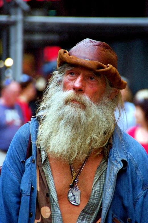 a long, skinny man in a cowboy hat with the beard