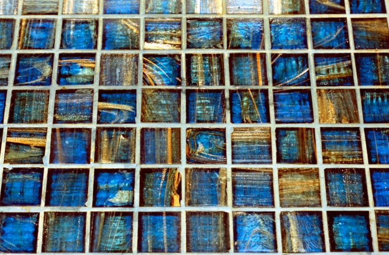 a very unique mosaic tile design in blue and gold
