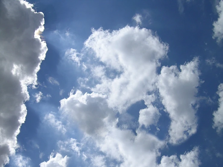 clouds floating in the sky over the top of the building