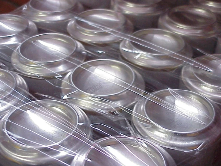 several clear cups of various sizes are in a clear container