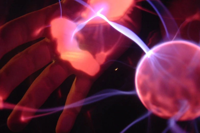 a hand is shown in red and purple lights