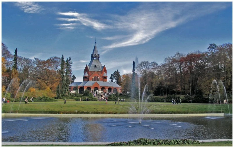 a large building surrounded by trees and water