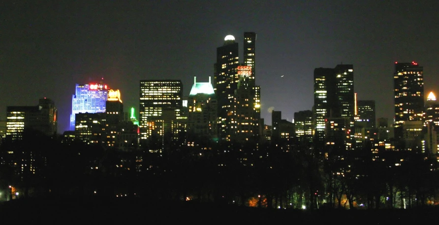 the city lights in the night, with skyscrs in the background