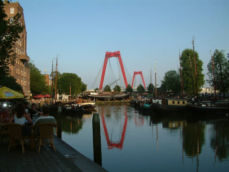 an amut park rides past a harbor with boats and restaurants