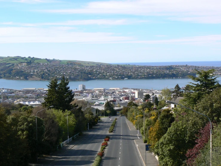 a road going through the countryside leading into the city