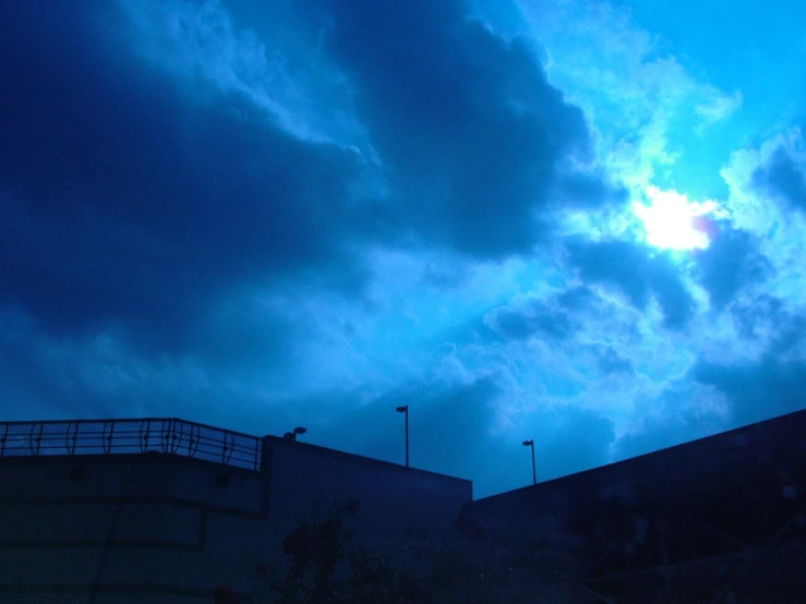 a cloudy night is seen above a parking lot