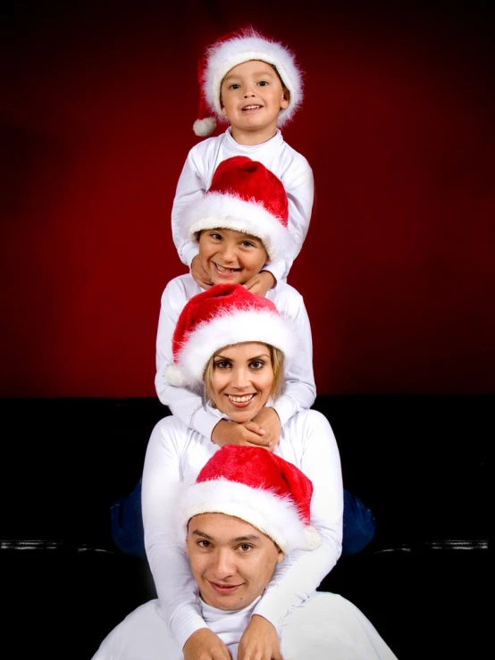 a man and woman are posing for the camera while holding two children