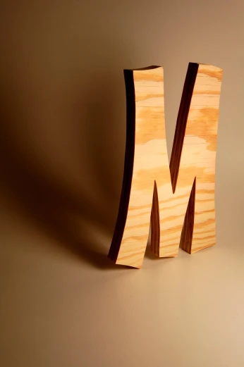a wooden block with the letter m carved into it