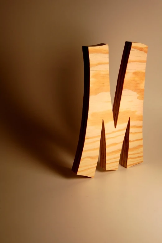 a wooden block with the letter m carved into it