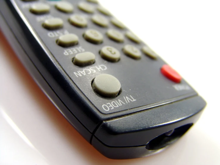 a remote control on a table sitting upright
