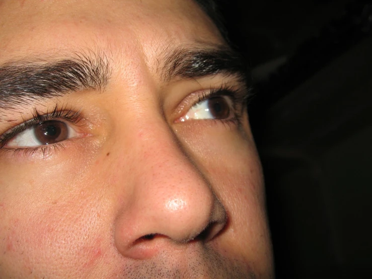 a closeup s of a young man's left eye with white contacts