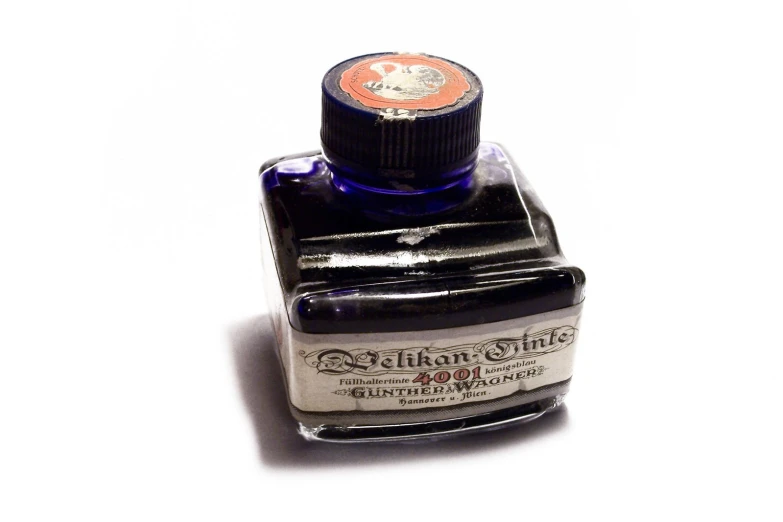 an ink bottle with a fountain marker on the bottom