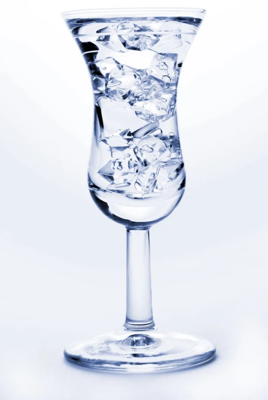 a glass filled with water sitting on top of a table