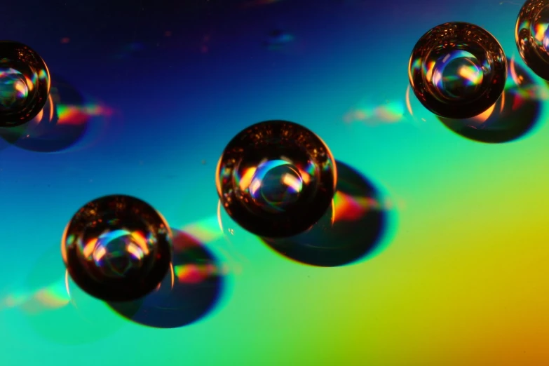 some bubbles on a multi colored background with rainbow light